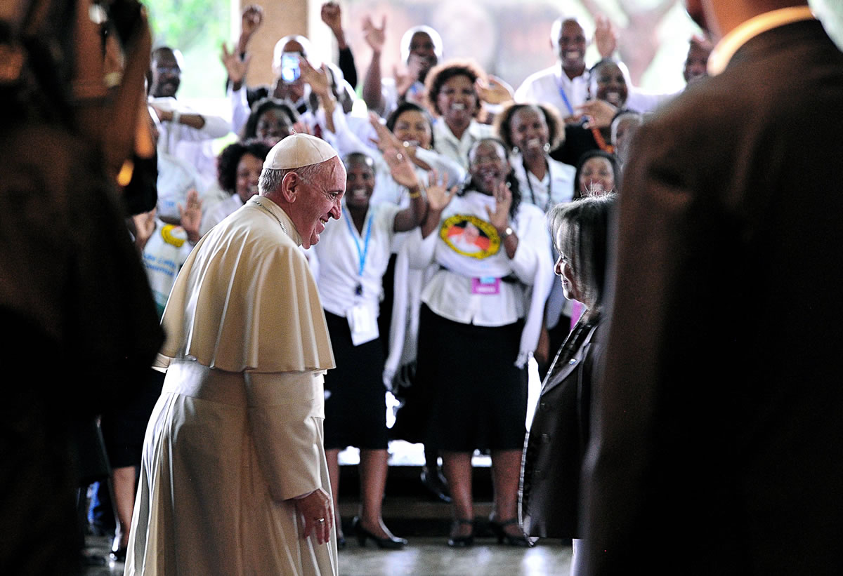 People cheer Pope Francis as he meets with Director-General of the United Nations Office at Nairobi Sahle-Work Zewde, right, upon his arrival at the United Nations regional office, in Nairobi, Kenya, on Thursday.