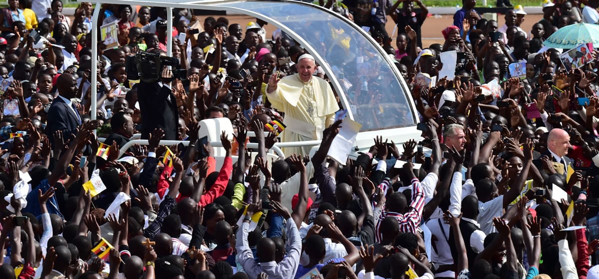 Pope Francis waves to young people Saturday at the Kololo airstrip in Kampala, Uganda. The pope is visiting  Kenya, Uganda and the Central African Republic during his six-day African trip.