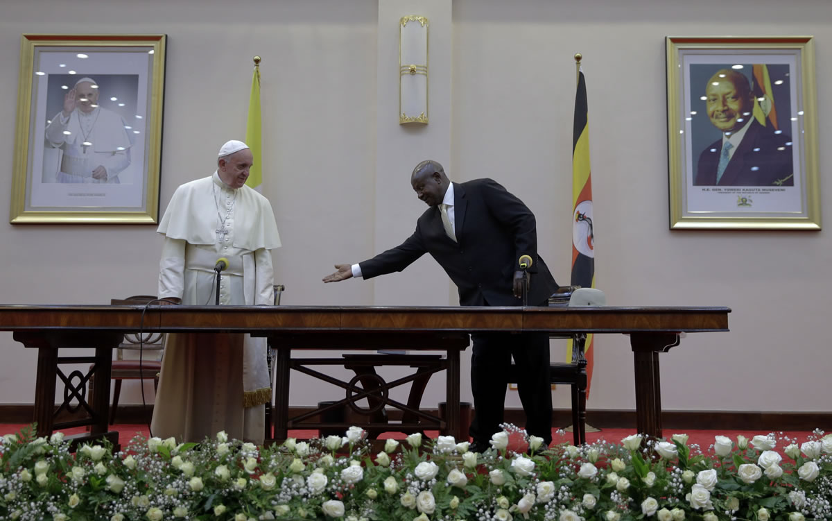 Pope Francis is greeted by Uganda&#039;s President Yoweri Kaguta Museveni at the State House, in Entebbe, Uganda, Friday, Nov. 27, 2015. Pope Francis is in Africa for a six-day visit that is taking him to Kenya, Uganda and the Central African Republic.