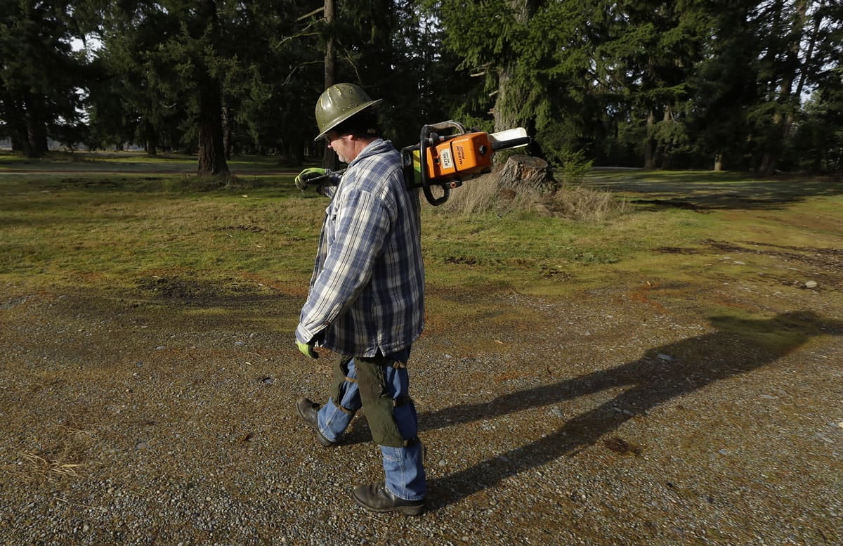Tom Edwards walks back to his truck  Thursday in the woods near Spanaway, Wash.