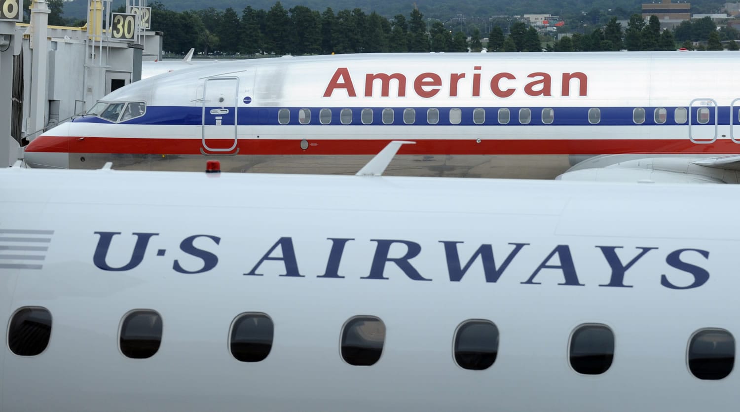 An American Airlines plane and a US Airways plane are parked at Washington's Ronald Reagan National Airport.