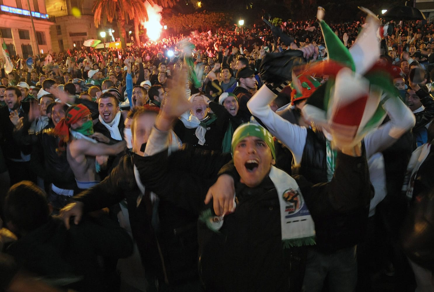 Algerian people celebrate their victory after the World Cup qualifying playoff second leg soccer match against Burkina Faso, in Algiers, on Tuesday.
