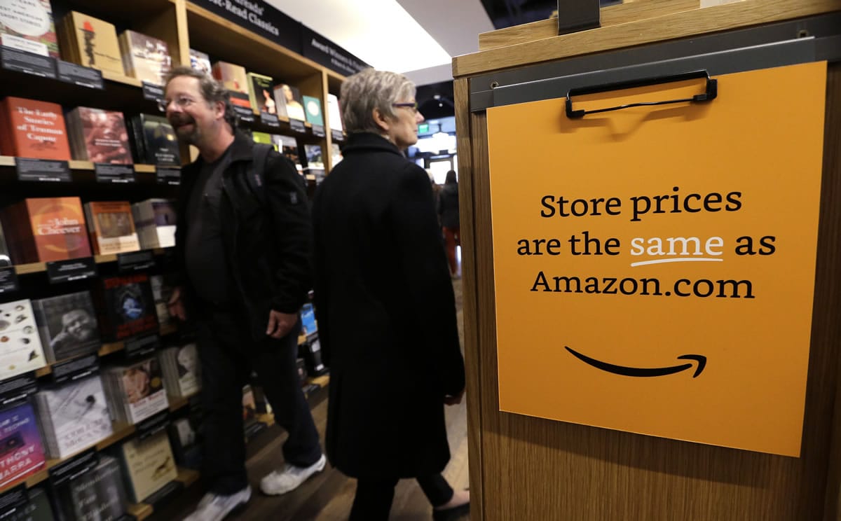 Customers shop on the opening day for Amazon Books, the first brick-and-mortar retail store for online retail giant Amazon, on Tuesday in Seattle.