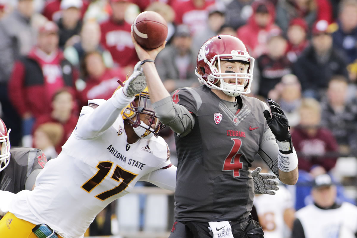 Washington State quarterback Luke Falk (4) passes as he is hit by Arizona State linebacker Ismael Murphy-Richardson (17) during the first half of an NCAA college football game, Saturday, Nov. 7, 2015, in Pullman, Wash.