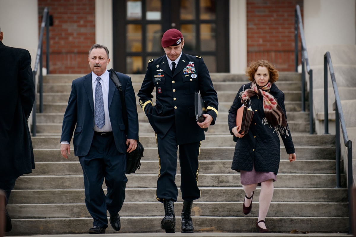 Brig. Gen. Jeffrey Sinclair leaves the courthouse with his lawyers Richard Scheff, left, and Ellen C.
