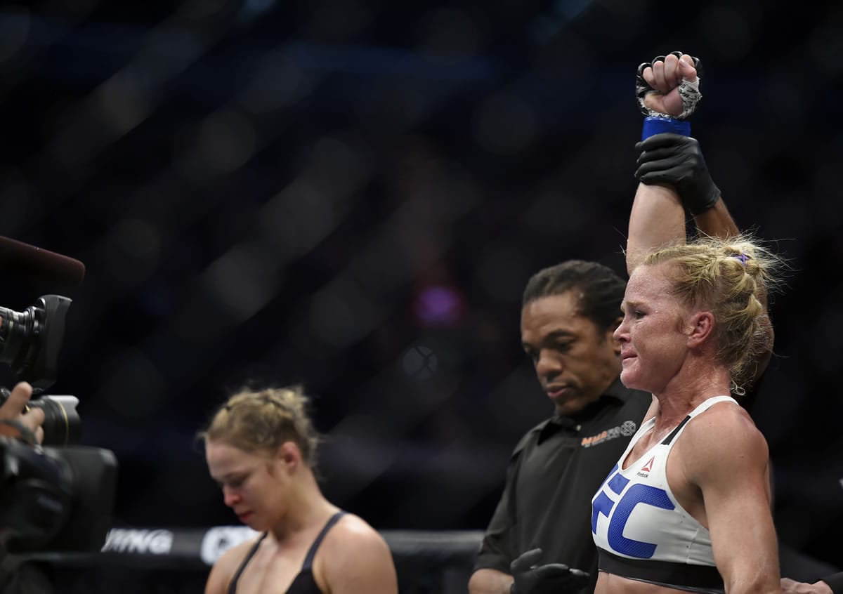 Holly Holm, right, celebrates after defeating Ronda Rousey, left, during their UFC 193 Bantamweight title fight in Melbourne, Australia, Sunday, Nov. 15, 2015.