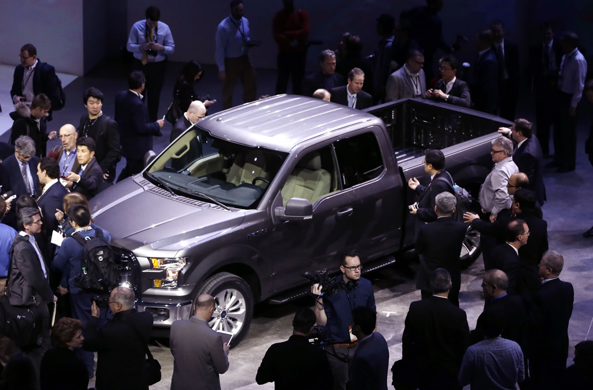 Journalists surround the new F-150 with a body built almost entirely out of aluminum at the North American International Auto Show in Detroit on Monday.