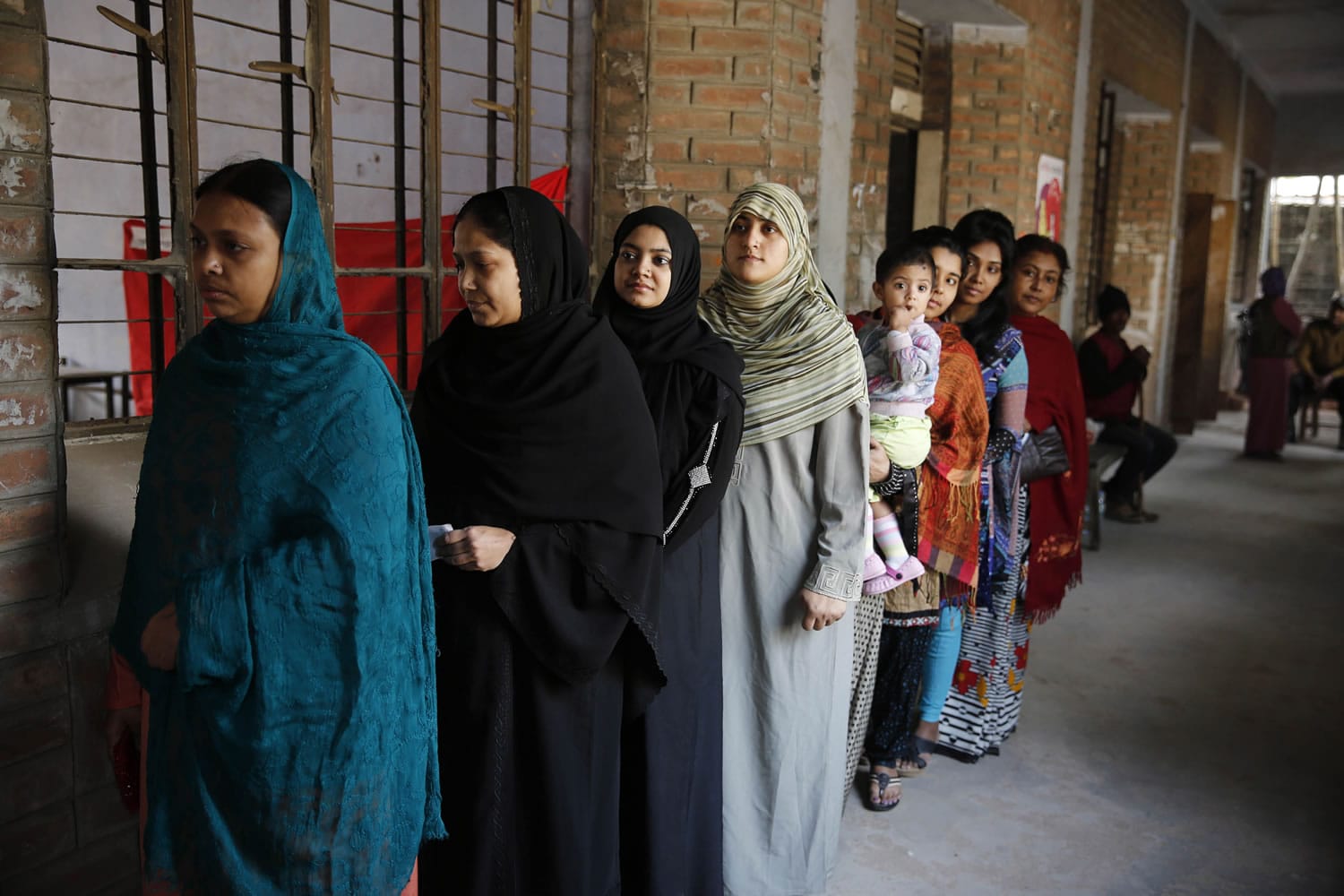 Bangladeshi women stand in a queue to cast their vote, at a polling station in Dhaka, Bangladesh, Sunday, Jan. 5, 2014. Police in Bangladesh fired at protesters and more than 100 polling stations were torched in Sundayis general elections marred by violence and a boycott by the opposition, which dismissed the polls as a farce.