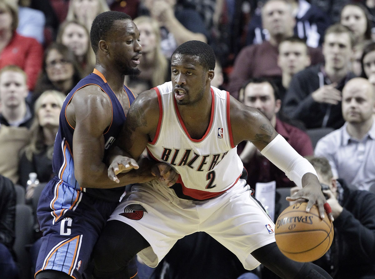 Portland Trails Blazers guard Wesley Matthews, right, works the ball in on Charlotte Bobcats guard Kemba Walker during the first half Thursday.