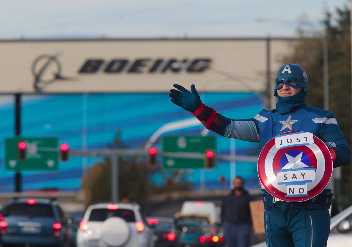 Dressed as Captain America, James White, a machinist with 17 years experience at Boeing encourages members to vote no during the shift change in Everett in November.