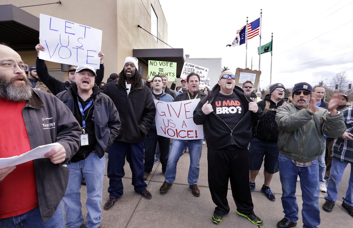 A small group of machinists union members rally in favor of voting on Boeing's last contract offer in front of the machinists' union hall Wednesday in Everett.