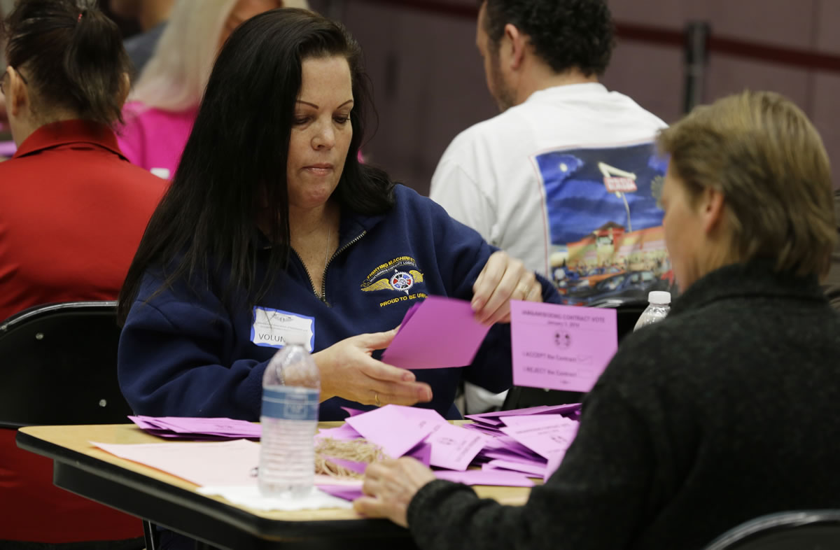 Volunteer vote counters tally ballots Friday at the Boeing Machinists union hall in Seattle.