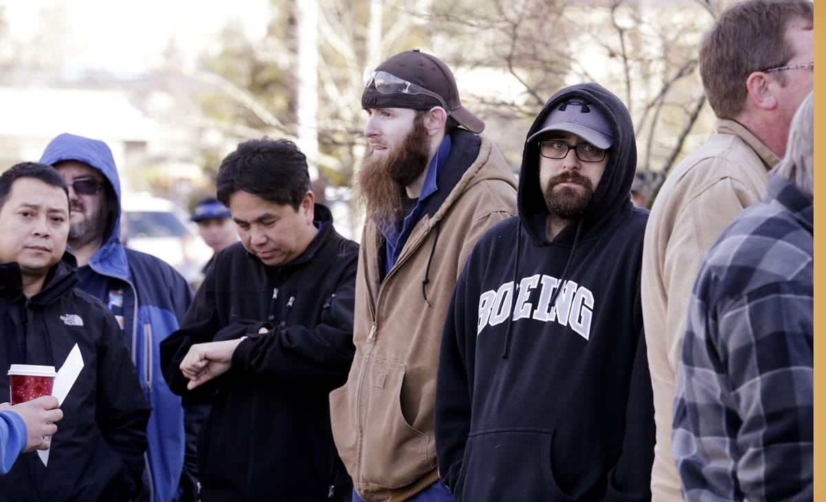 Boeing machinists stand in a line of several hundred as they wait to cast their ballots on Friday in Everett.