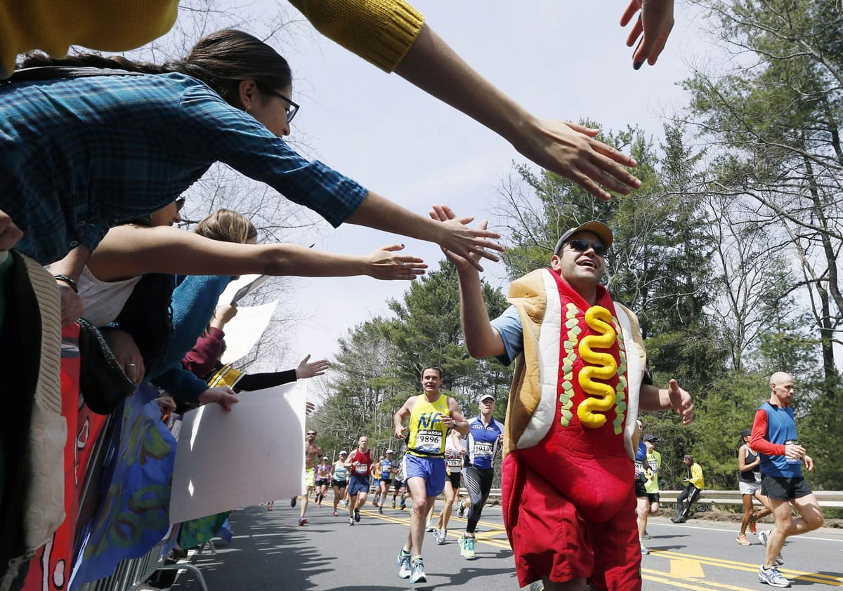 A man dressed as a hot dog runs through Wellesley, Mass., during the 117th running of the Boston Marathon in 2013.