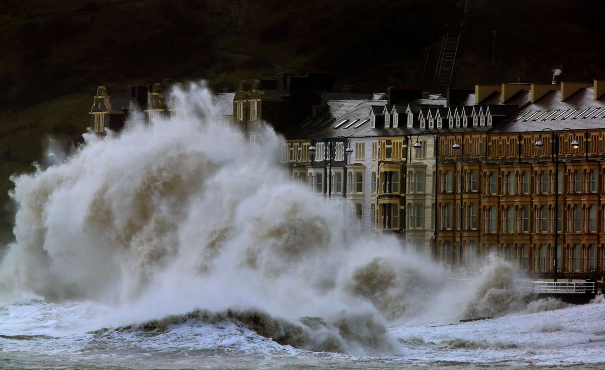 Waves crash against the Aberystwyth coastline in Wales,  as strong winds and high tides continue to blow in from the west Monday.