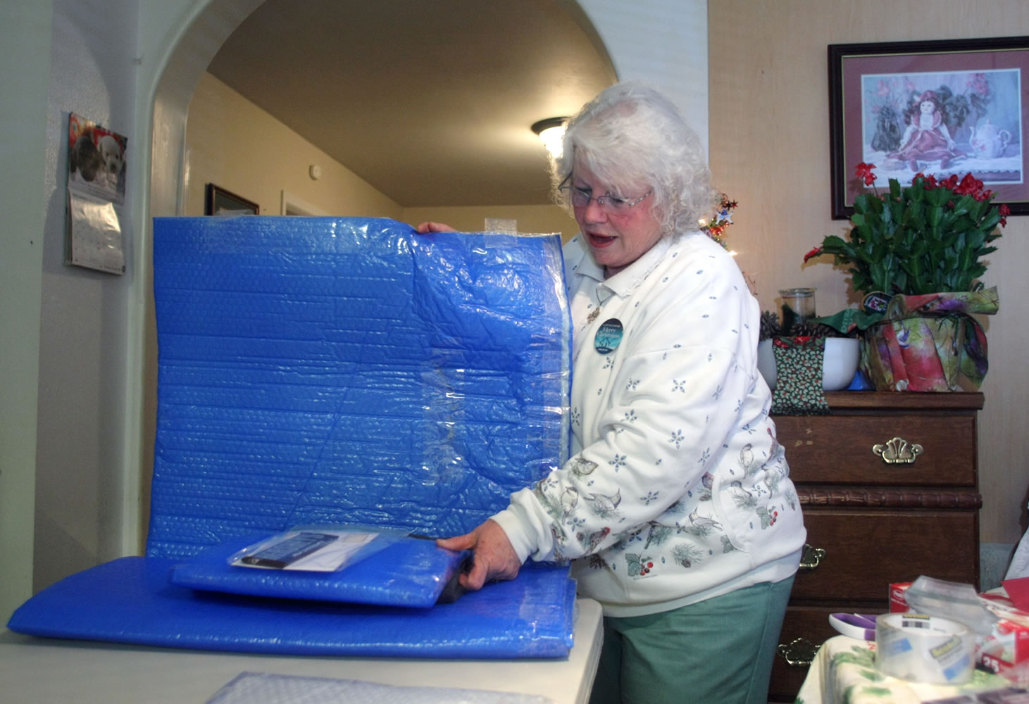 Sheri Rose puts a pillow inside one of her completed homeless mats Dec.