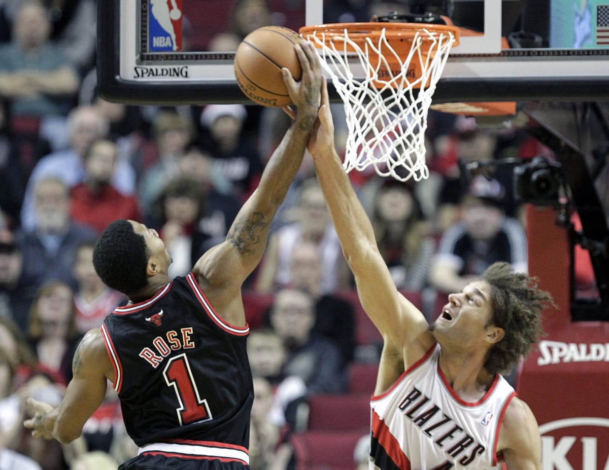 Portland's Robin Lopez, right, blocks a shot by Chicago's Derrick Rose during the first half Friday.