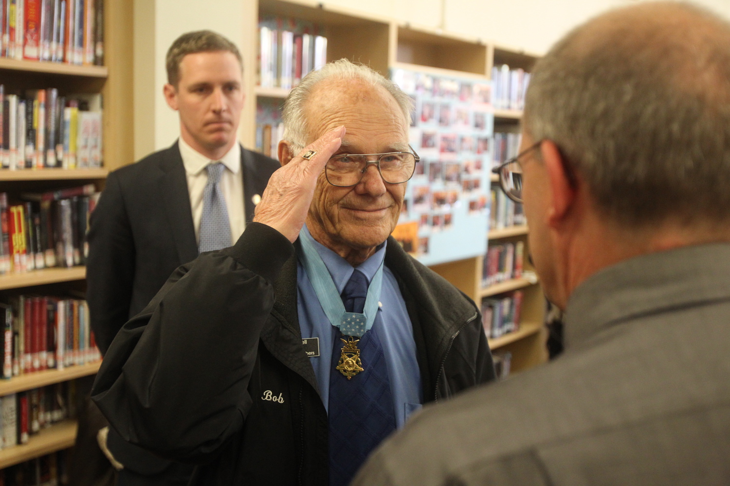 Photos by Andy Tullis/The Bulletin
Bob Maxwell, Medal of Honor recipient, center, attends a ceremony where he received the commemorative stamp from the U.S. Postal Service local postmaster in the library at Bend High School in Bend, Ore., on Friday.