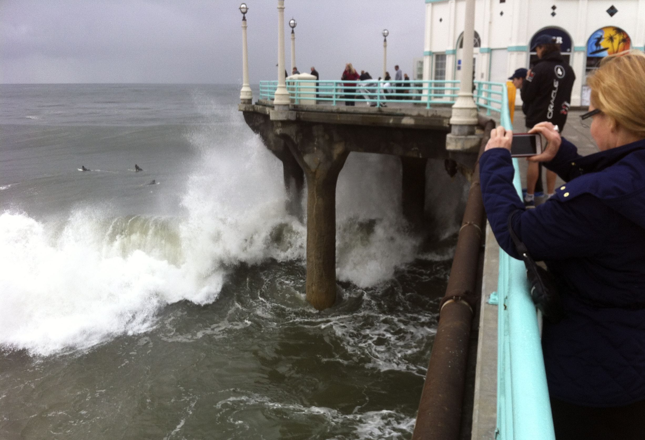 Big surf pounds the pier Sunday at Manhattan Beach, Calif., in the aftermath of a powerful storm.