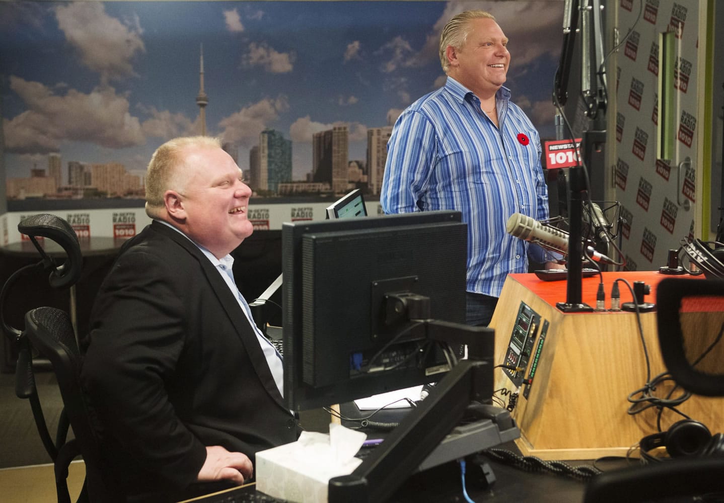 Toronto Mayor Rob Ford and his brother, Toronto city councillor Doug Ford, right, appear on a radio show Sunday in Toronto.