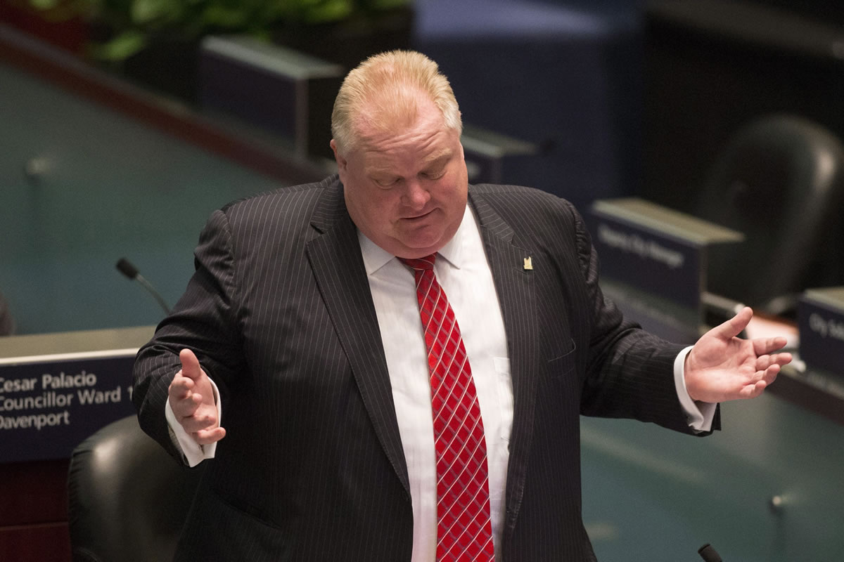 Toronto Mayor Rob Ford attends a council meeting as councillors look to pass motions to limit his powers in Toronto on Monday.