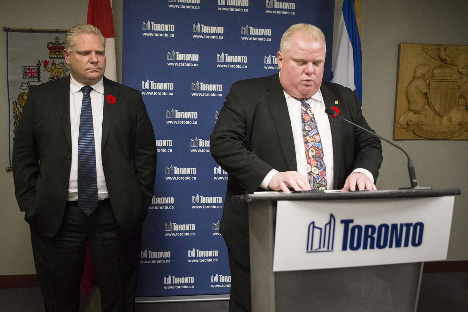 Toronto Mayor Rob Ford addresses the media at City Hall as his brother city councillor Doug Ford, left, looks on Tuesday in Toronto.