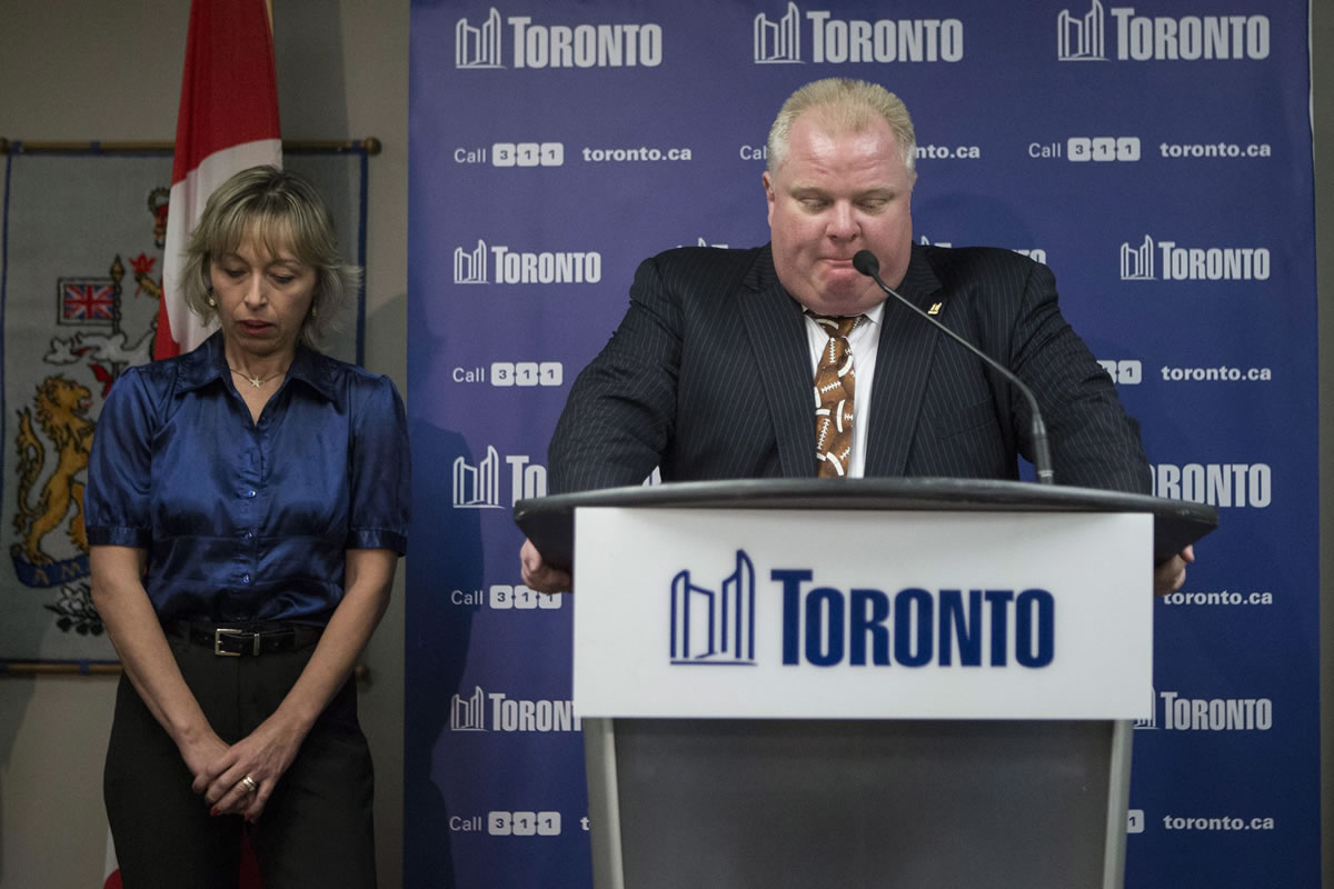 Toronto Mayor Rob Ford stands with his wife, Renata, at a news conference on Thursday.