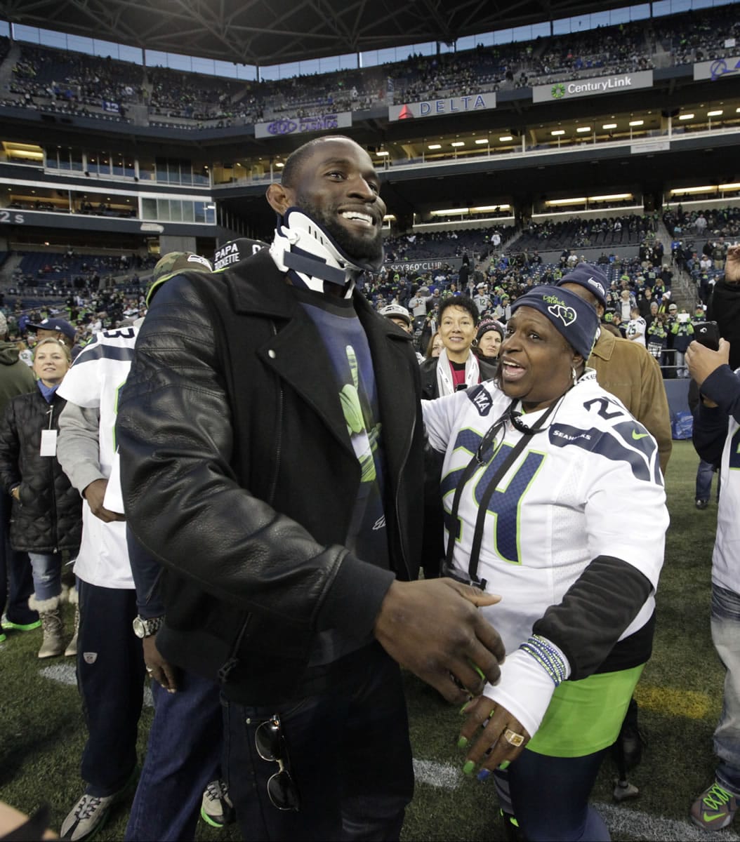 Injured Seattle Seahawks wide receiver Ricardo Lockette wears a neck brace as he is greeted by Delisa Lynch, right, the mother of Seahawks running back Marshawn Lynch, as Lockette arrives at CenturyLink Field before an an NFL football game against the Arizona Cardinals, Sunday, Nov. 15, 2015, in Seattle.
