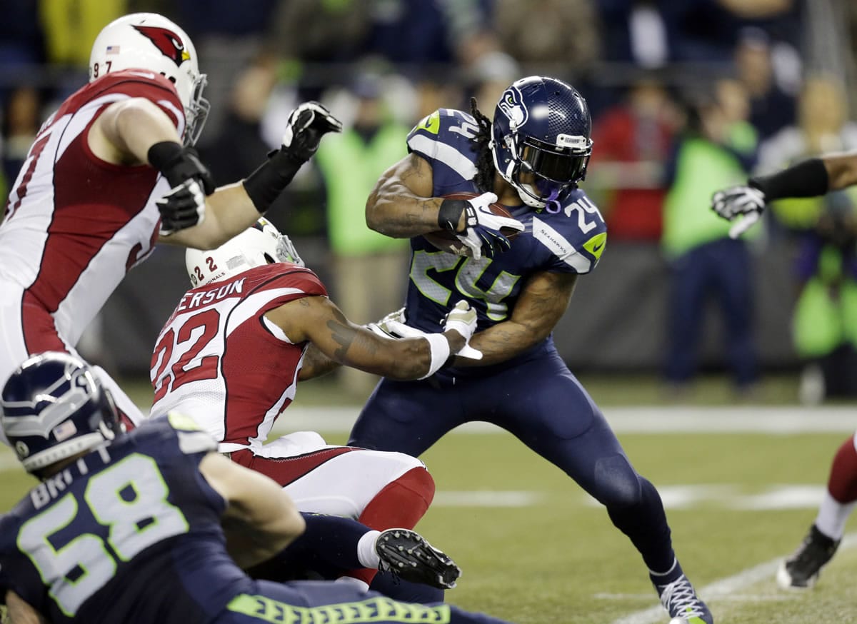 Seattle Seahawks running back Marshawn Lynch (24) rushes as Arizona Cardinals strong safety Tony Jefferson (22) attempts the tackle in the first half of an NFL football game Sunday, Nov. 15, 2015, in Seattle.