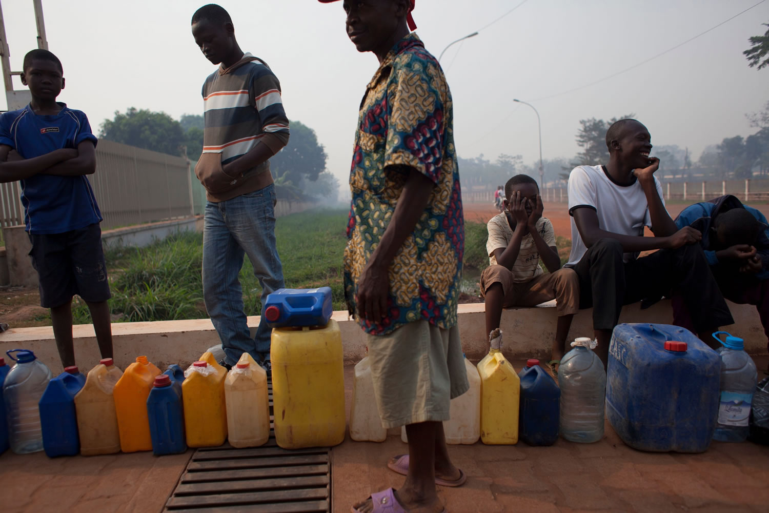People waiting to purchase fuel hold their places in line with jerrycans at a gas station that was closed, as they await the arrival of military police, in Bangui, Central African Republic, on Tuesday.