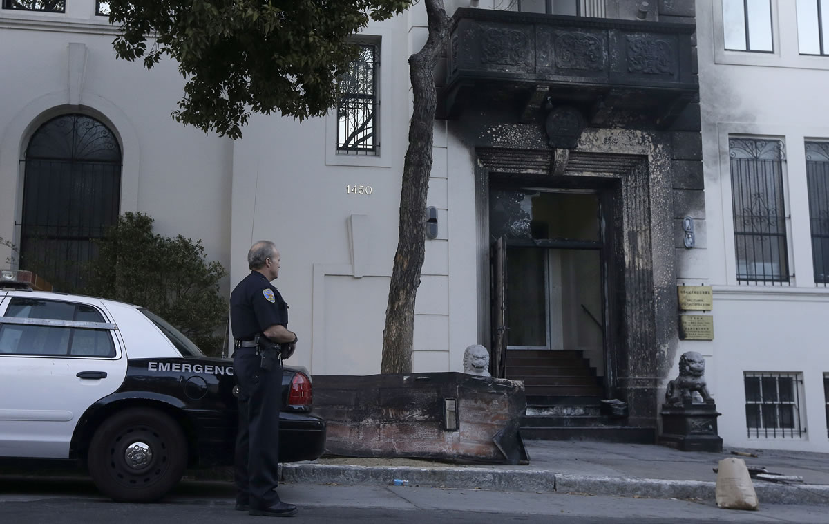 A San Francisco Police officer stands outside of the damaged entrance to the Chinese Consulate on Thursday in San Francisco.