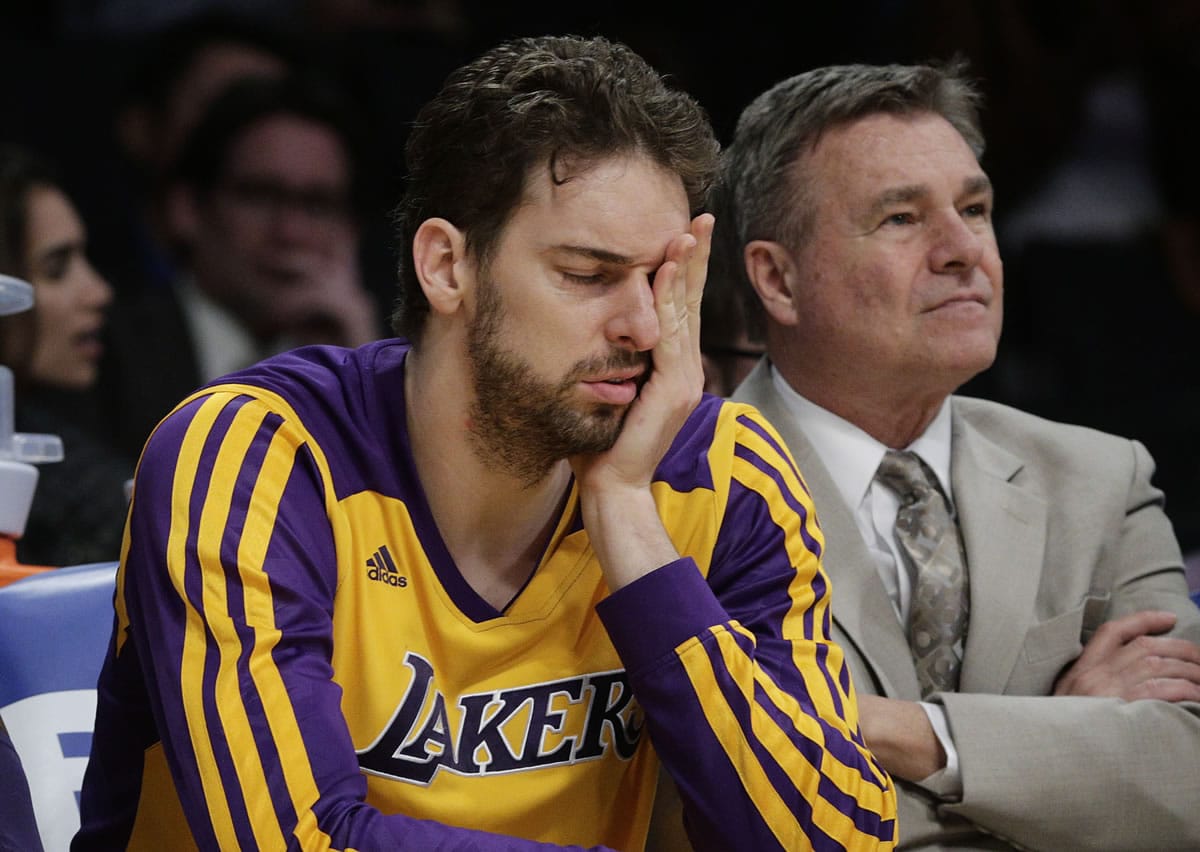 Los Angeles Lakers' Pau Gasol, of Spain, covers his face while sitting on the bench during the second half of an NBA basketball game against the Los Angeles Clippers on Thursday, March 6, 2014, in Los Angeles. The Clippers won 142-94. (AP Photo/Jae C.