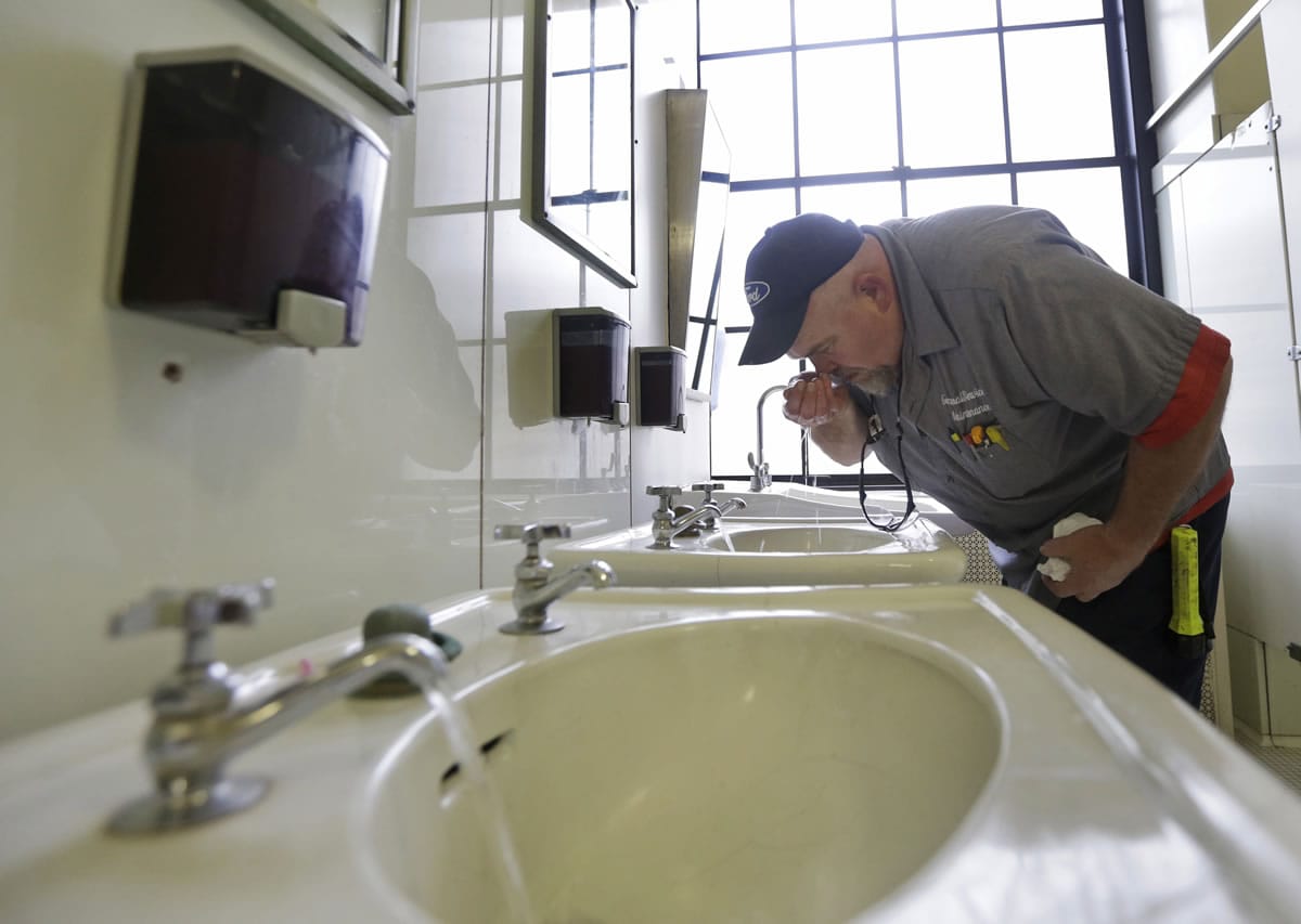Al Jones of the West Virginia department of General Services tests the water Jan. 13 as he flushes the faucet and opens a rest room on the first floor of the State Capitol in Charleston, W.Va., The chemical spill that contaminated water for hundreds of thousands of West Virginians is just the latest and most high-profile case of coal polluting the nation's waters.
