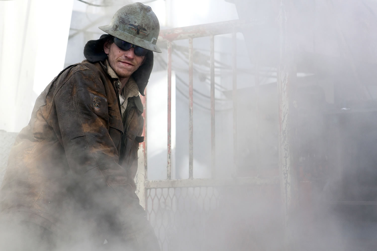 Ray Gerish, an employee of Raven Drilling, de-ices the floor of a drilling rig with steam in Watford City, N.D., on Thursday.