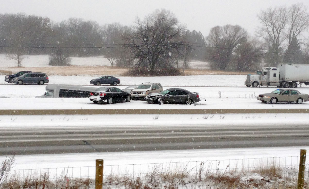Emergency personnel respond Sunday to the scene of an accident on Interstate 94 south of Milwaukee, near Racine, Wis. Snow is causing treacherous driving conditions in southeastern Wisconsin. Multiple accidents have been reported on Interstates 94 and 894, as well as I-39 and I-90.