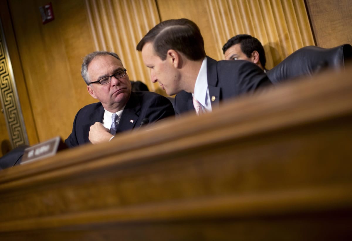 In this July 9, 2014, file photo, Senate Foreign Relations Committee members Sen. Tim Kaine, D-Va., left, and Sen. Christopher Murphy, D-Conn., participate in a committee hearing on Capitol Hill in Washington. In the fight against the Islamic State group, members of Congress talk tough on extremism, but most want nothing to do with voting to legally authorize the military campaign, preferring to let the president take ownership of the mission.