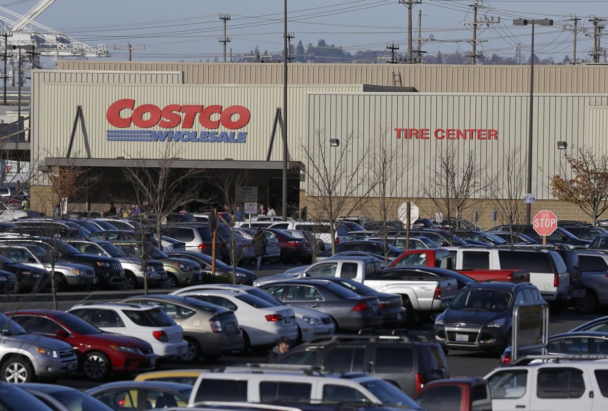 Cars fill the parking lot of a Costco store, Tuesday, Nov. 24, 2015, in Seattle. Health authorities say chicken salad from Costco has been linked to at least one case of E. coli in Washington state.  (AP Photo/Ted S.