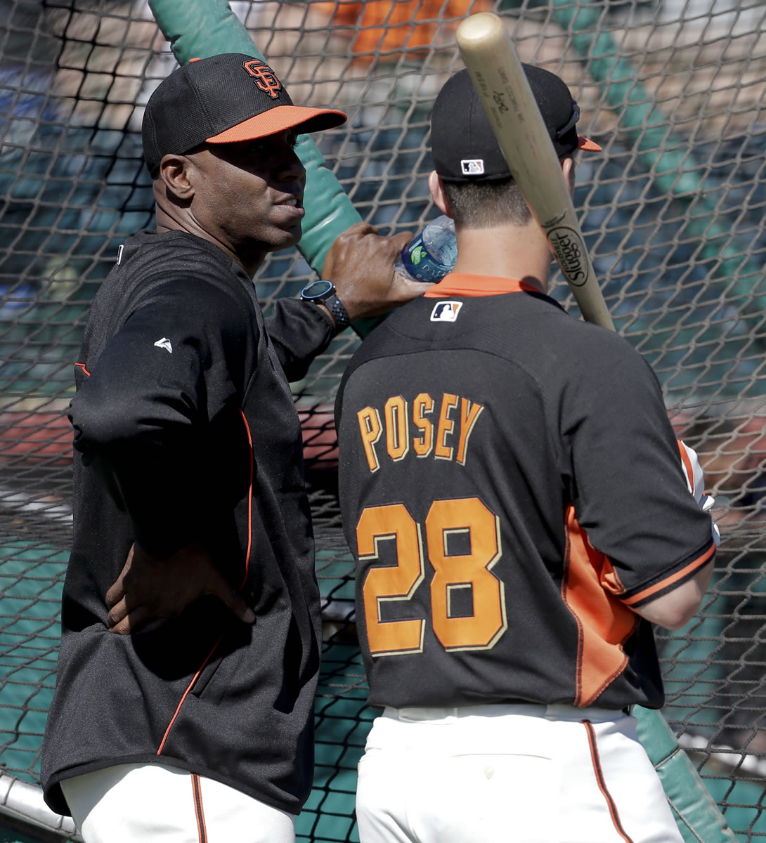 San Francisco Giants former player Barry Bonds, left, chats with catcher Buster Posey during batting practice.