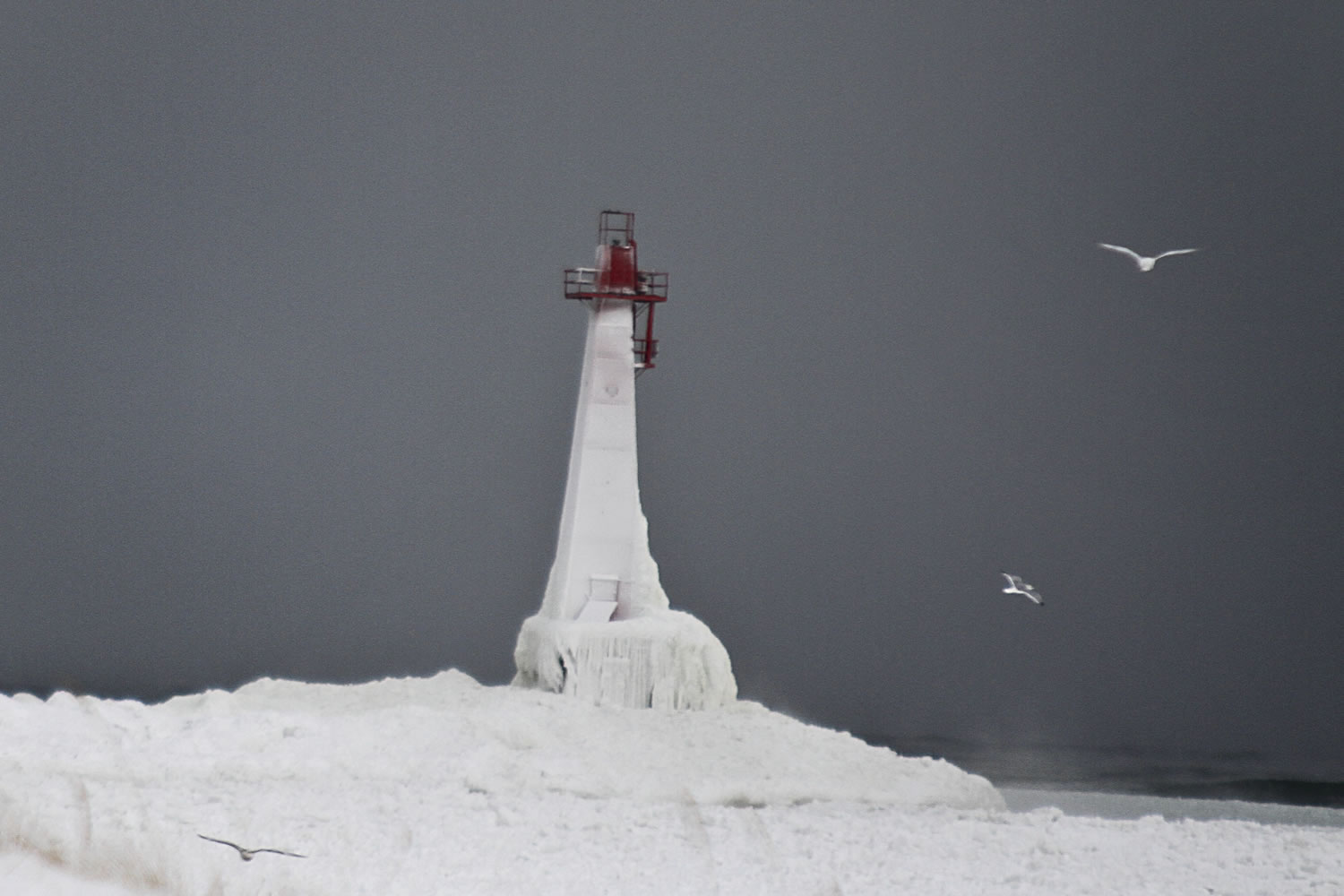 The lighthouse at Pere Marquette Beach is completely frozen after a severe winter storm hit Tuesday in Muskegon, Mich.