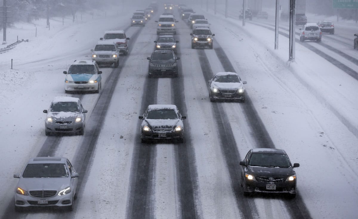 Motorists drive along a snow covered northbound Interstate-94 in Chicago on Sunday.