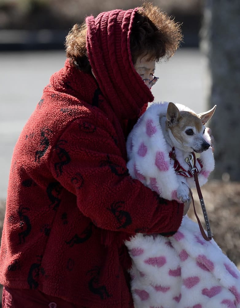 Doc Cheng bundles up with her chihuahua, Happy, as she braves a cold Arctic blast that brought temperatures down to 6 degrees Tuesday in Atlanta.