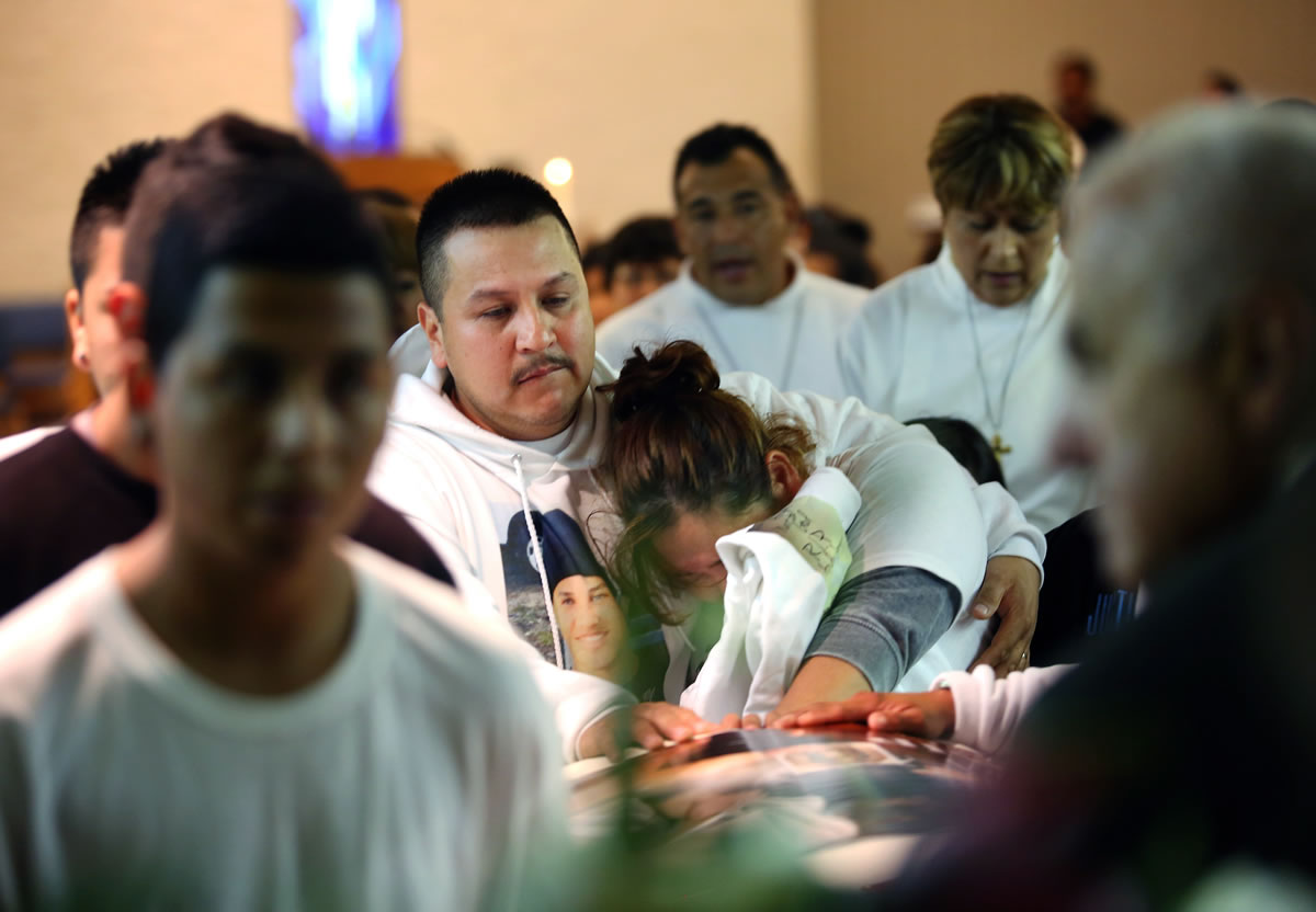 Rodrigo Lopez and his wife, Sujey Lopez, touch the coffin holding the remains of their 13-year-old son, Andy Lopez, as it is carried out of Resurrection Parish in Santa Rosa, Calif.,  on Oct. 29. Lopez was shot by a Sonoma County deputy on Oct.
