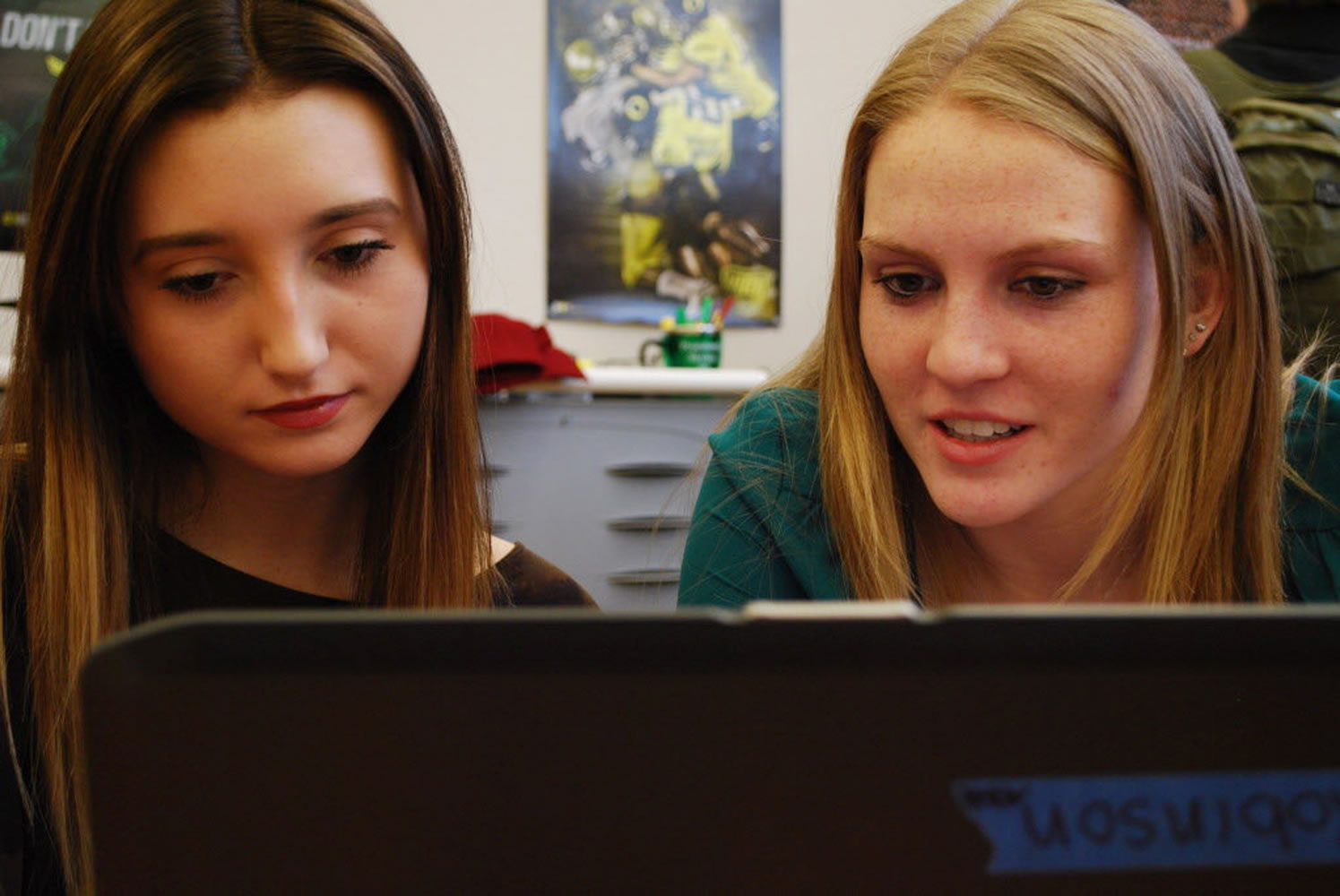 Beaverton High School Social Media teammates Paige Colorito, left, and Casey Wise work on a story about the Beaverton Police Department, in Beaverton, Ore.