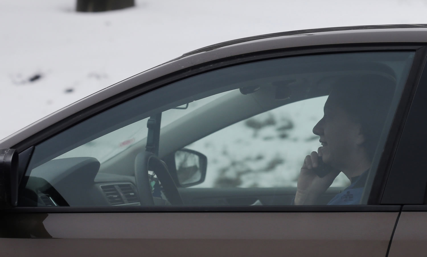 A motorist talks on a cell phone while driving on an expressway in Chicago.