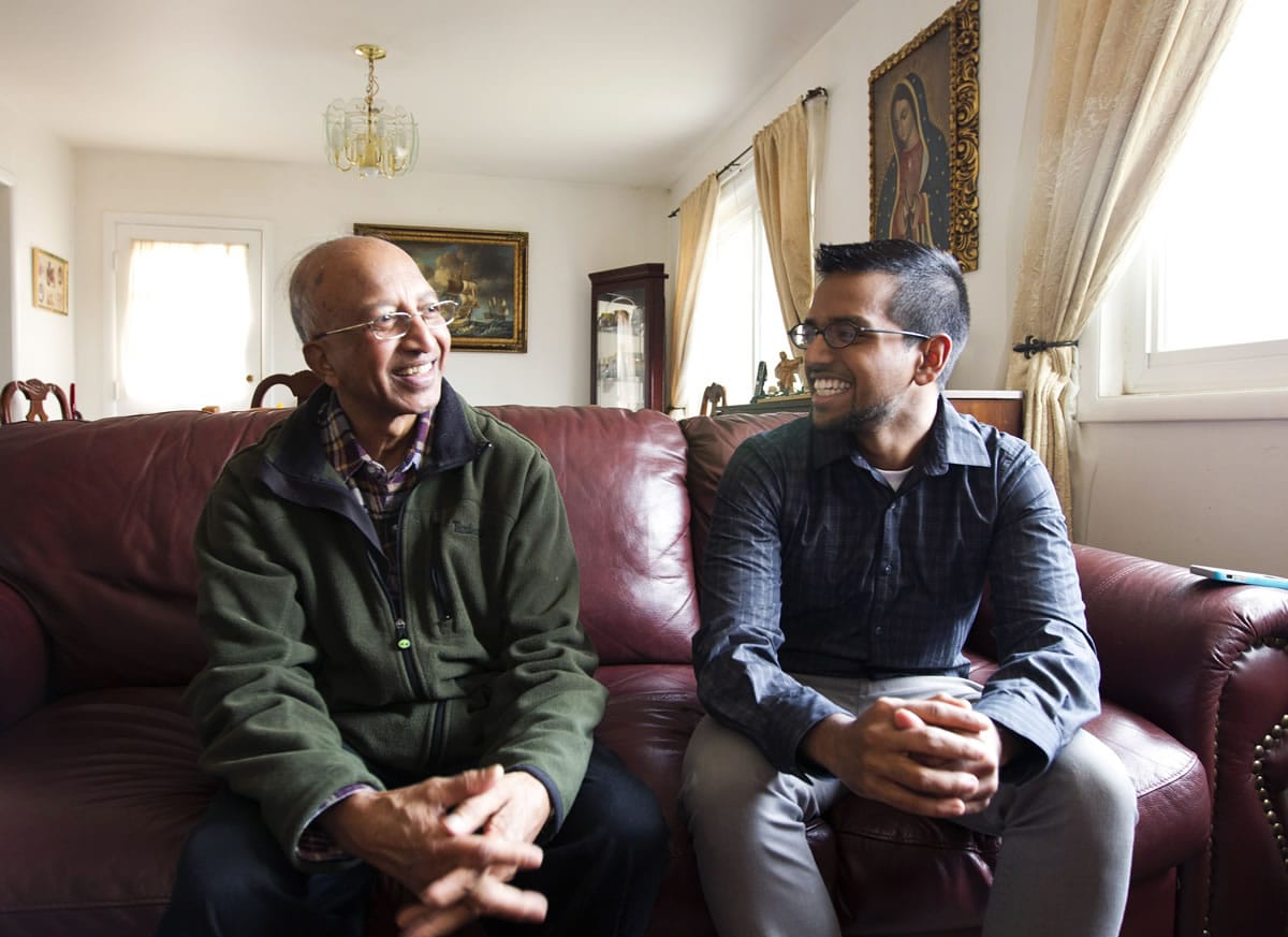 College student Yves Gomes, right, talks to his great uncle Henry Gomes in his great uncle's house in Silver Spring, Md.