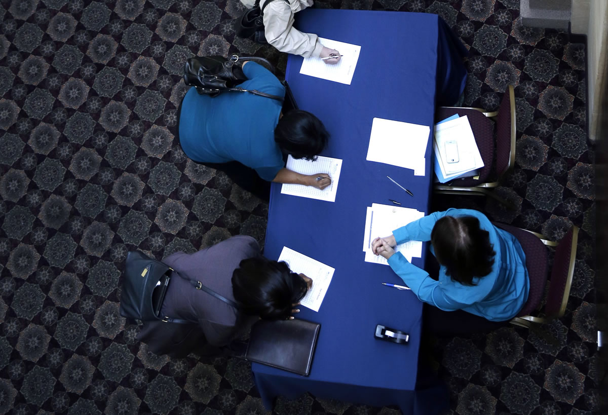 Job seekers line up to sign in before meeting prospective employers at a career fair at a hotel in Dallas on Jan. 22. The Labor Department announced Friday that 175,000 jobs were added across the U.S.