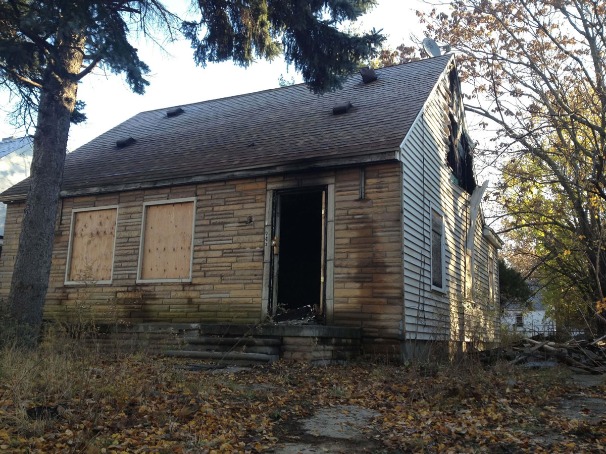 Fire crews responded Thursday evening to the boarded-up bungalow that was the childhood home of rapper Eminem in Detroit. The house is pictured on the cover of Eminem's just-released &quot;The Marshall Mathers LP 2.&quot; It also was on the musician's 2000 album &quot;The Marshall Mathers LP.&quot; The blaze damaged portions of the small home's top floor.