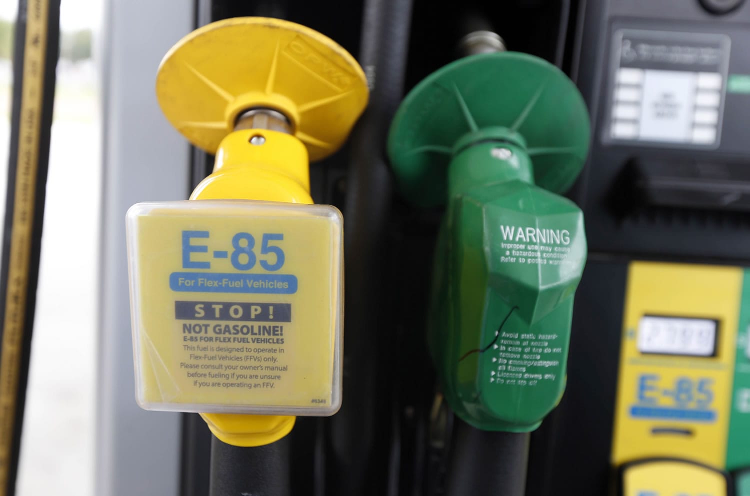 A fuel nozzle for E-85, left, and traditional gasoline is seen at a gas station in Batesville, Miss. (AP Photo/Rogelio V.
