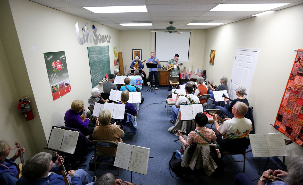 In this Nov. 15, 2015, people attend a Ukulele Fans of Oregon gathering at LifeSource in Salem, Ore. The group meets on the third Sunday of each month at the LifeSource Community Room.