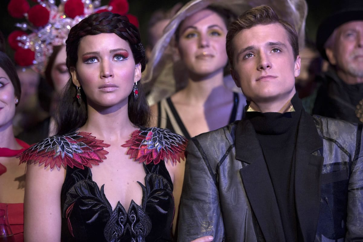 Jennifer Lawrence plays Katniss Everdeen, left, and Josh Hutcherson is Peeta Mellark in  &quot;The Hunger Games: Catching Fire.&quot;